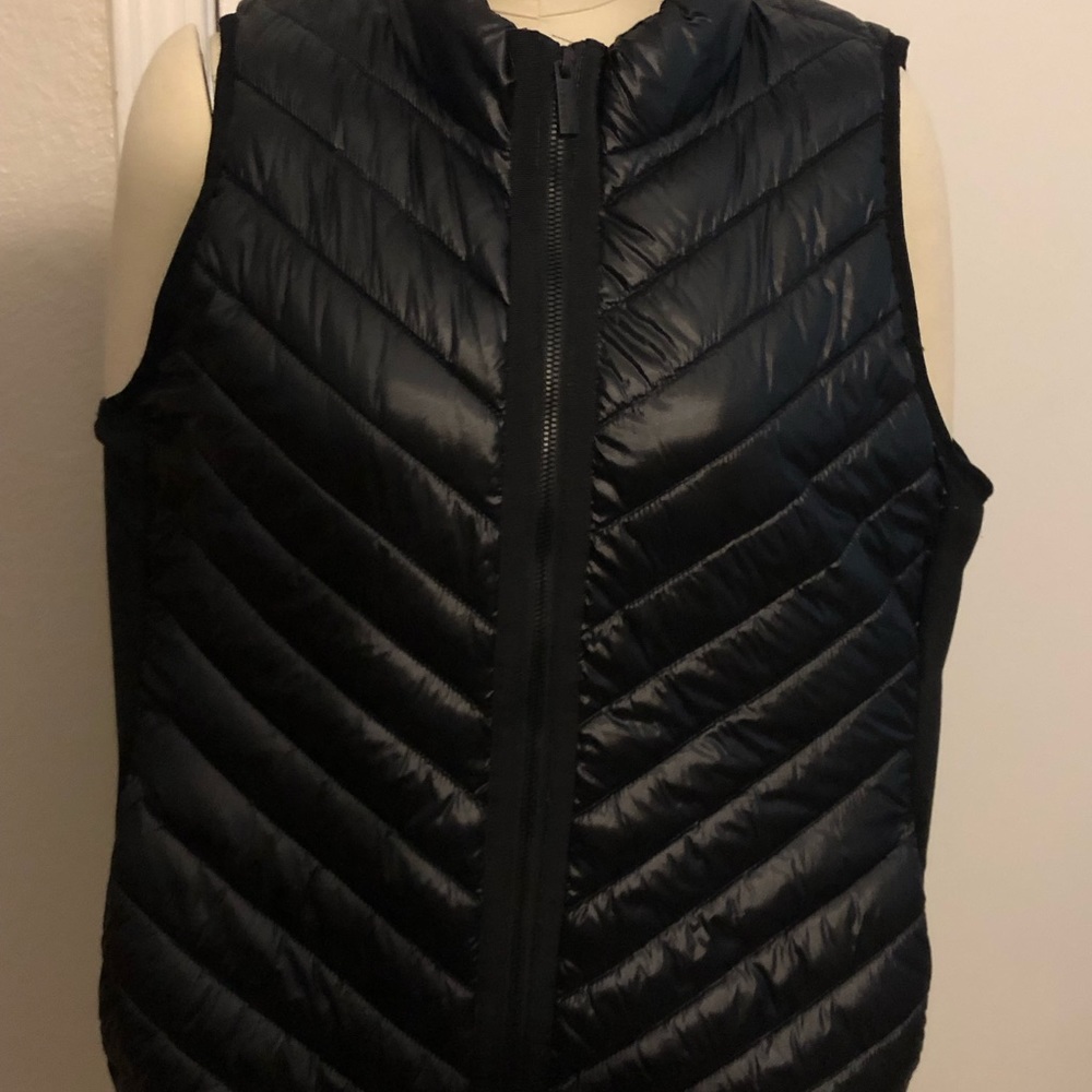 Calvin Klein shiny black vest. Size Large, zipper front and zipper slit pockets.